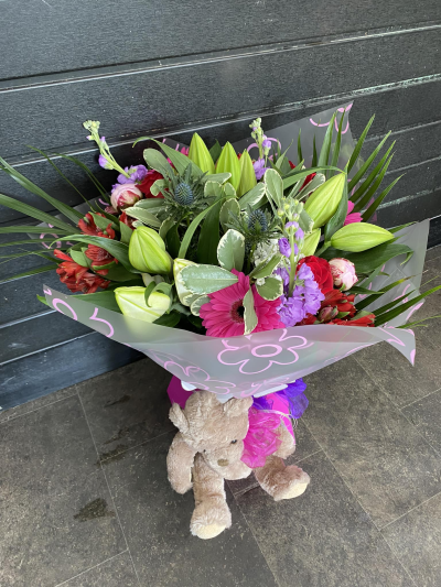 Blushing Meadow - A stunning collection of pink and green seasonal flowers in toning packaging. This bouquet is designed to impress and uplift any space.