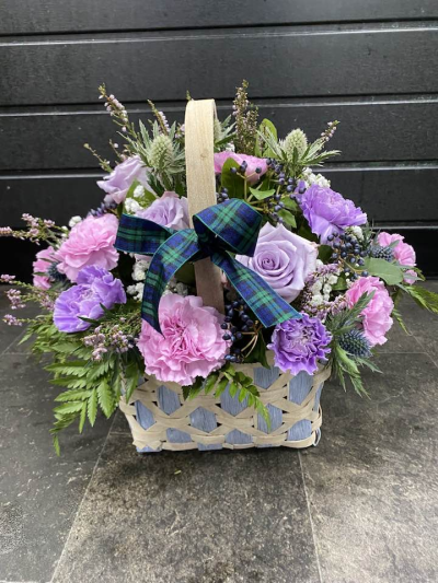 Bon Bon - Shower them with love with this cutesy collection of seasonal flowers in pretty pastels. Beautifully arranged and stylishly presented in a traditional basket.