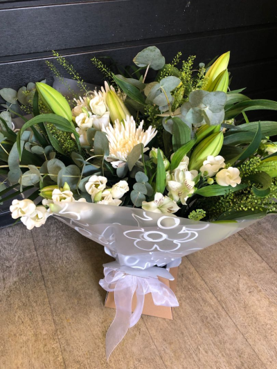 Evelyn - A fabulous collection of white and cream flowers make this the perfect gift. This bouquet will be hand delivered by the local florist.