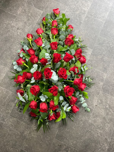 Single Ended Spray SYM-305 - This single ended spray is made using symbolic red roses for the perfect loving tribute. Same day delivery may not be possible on this design – please contact us to discuss your requirements.