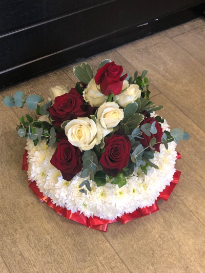 Posy SYM-344 - A delightful funeral posy featuring a white massed base and a red rose spray, handmade by our in-house florists using market fresh flowers.