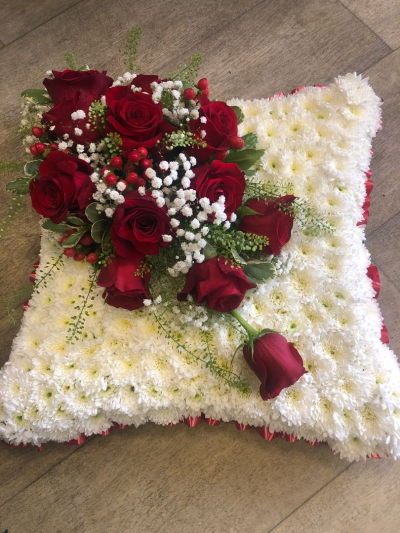 Pillow SYM-333 - Pillows are chosen to signify a final, comfortable resting place and this design with red rose spray is the ideal final tribute.