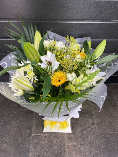 Citrus Sunrise - Capture the essence of a golden meadow with this stunning bouquet of yellow, white, and orange flowers. Presented in a stylish packaging it's perfect for adding natural beauty to any space